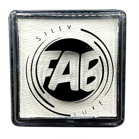 A close-up of a container of Silly Farm FAB Luxe white face and body paint with the brand logo visible on the label.