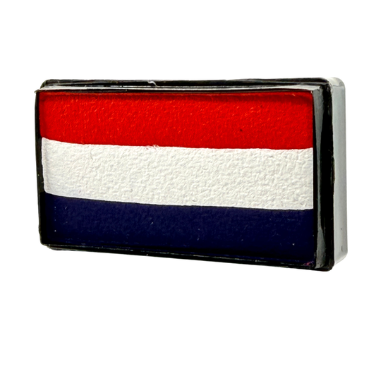 Rectangular one-stroke face paint cake with horizontal stripes of bright red, white, and deep navy blue inside a black plastic container, inspired by classic patriotic color combinations.