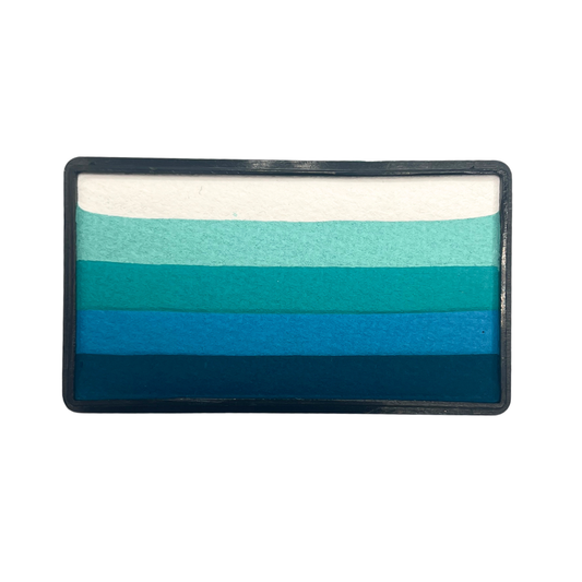 Rectangular one-stroke face paint cake with layered ocean-inspired tones including white, aqua, teal, turquoise, bright blue, and deep navy blue inside a black plastic container.