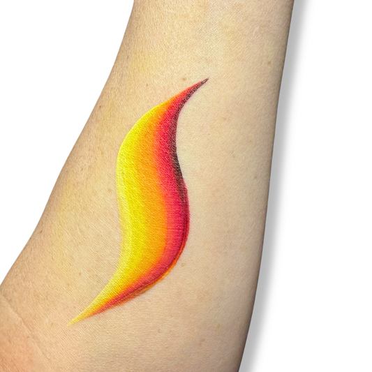 Colorful swatch of a face paint combination that looks like flames line on a person's arm with a white background