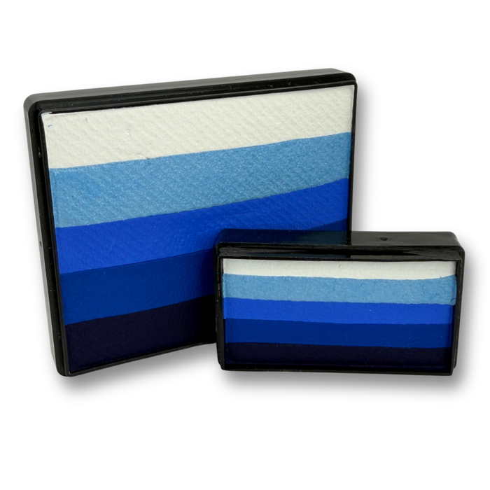 Out of the Blue face paint bundle featuring a 50g Rainbow Cake and 28g Arty Cake with layered white and blue gradient colors for one-stroke face painting designs.