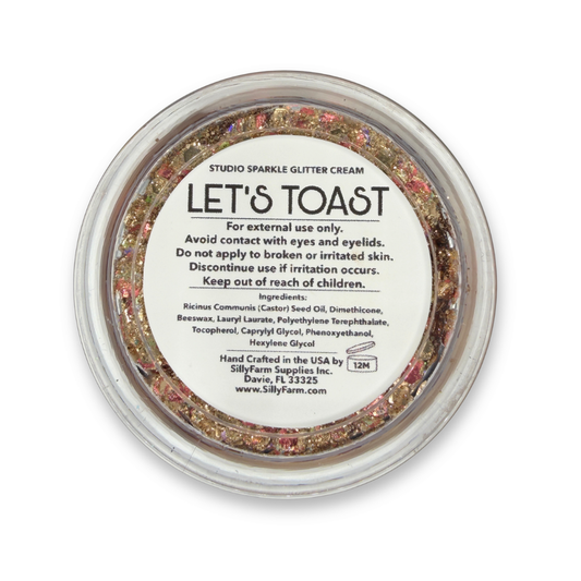 Back view of Let's Toast Studio Sparkle Glitter Cream container showing the product label, ingredients, safety information, and usage details.