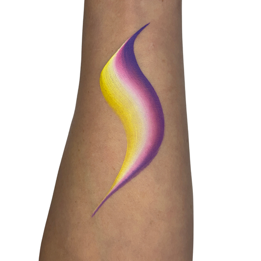 a face paint swatch on skin with yellow, white pink and purple