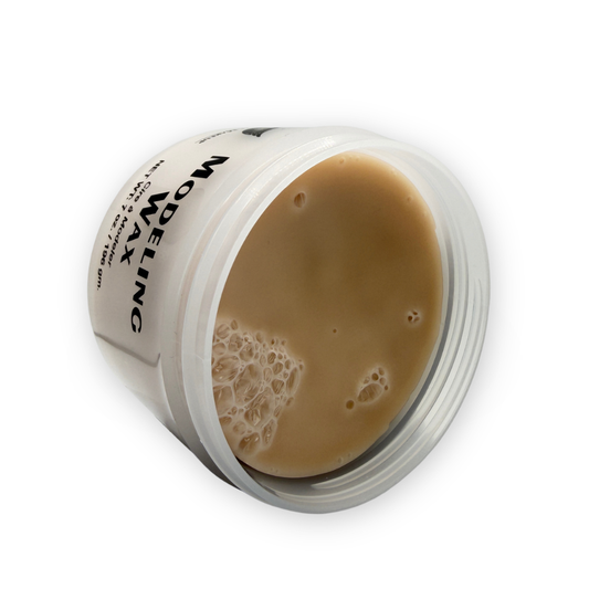 A clear plastic jar of Graftobian modeling wax with a white label, showing the light tan wax inside against a white background.