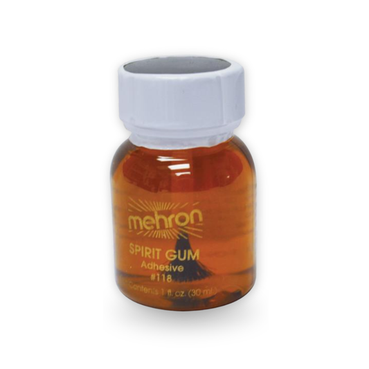 A small amber bottle of Mehron Spirit Gum Adhesive with a white cap, shown on a white background.