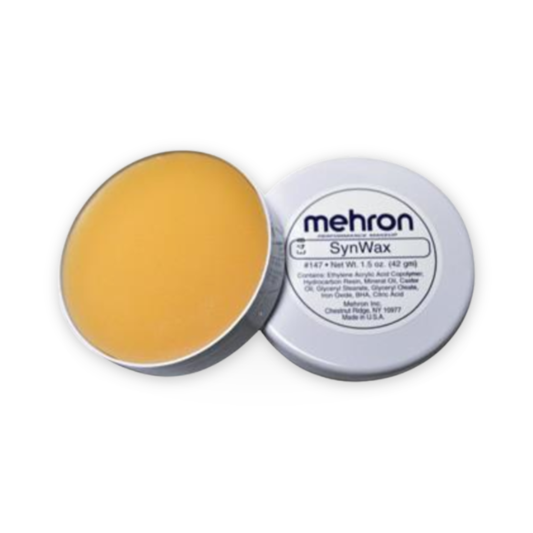 Mehron SynWax synthetic wax in a round metal tin, with the lid off to show the golden-yellow wax inside and the white label on the other side.