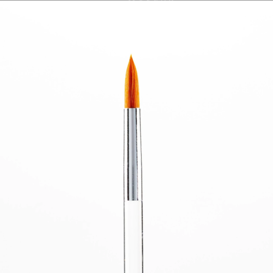 A close-up of a fine makeup brush with a pointed orange bristle tip, a silver metal ferrule, and a clear handle, centered on a plain white background.