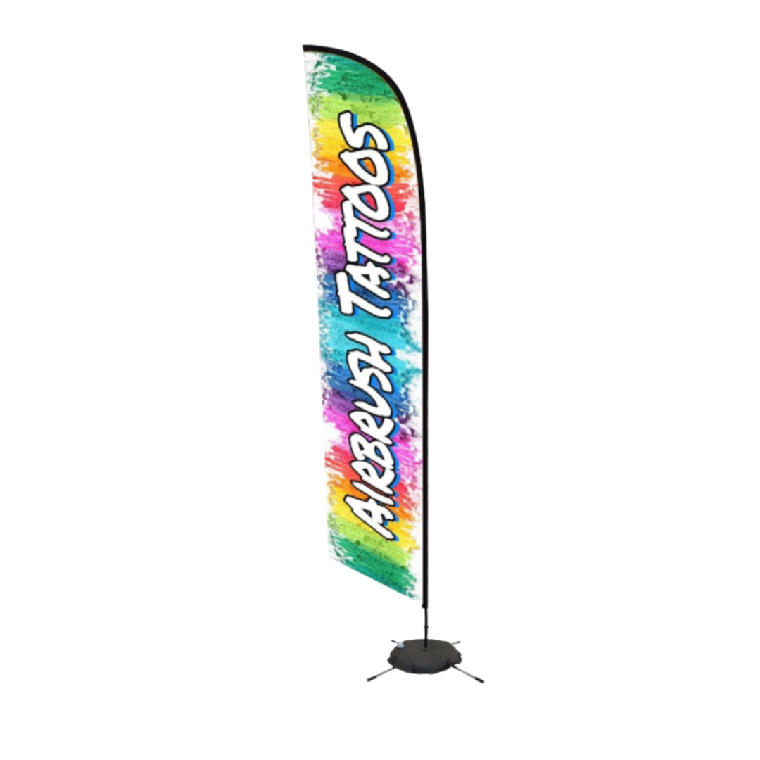 Colorful event flag banner featuring the words "Airbrush Tattoos" on a rainbow paint-splash background. Display shown assembled with pole, base, and water weight bag.