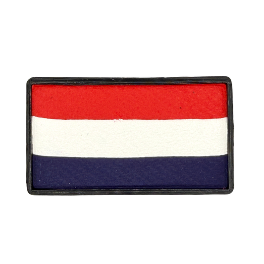 Rectangular one-stroke face paint cake with horizontal stripes of bright red, white, and deep navy blue inside a black plastic container, inspired by classic patriotic color combinations.