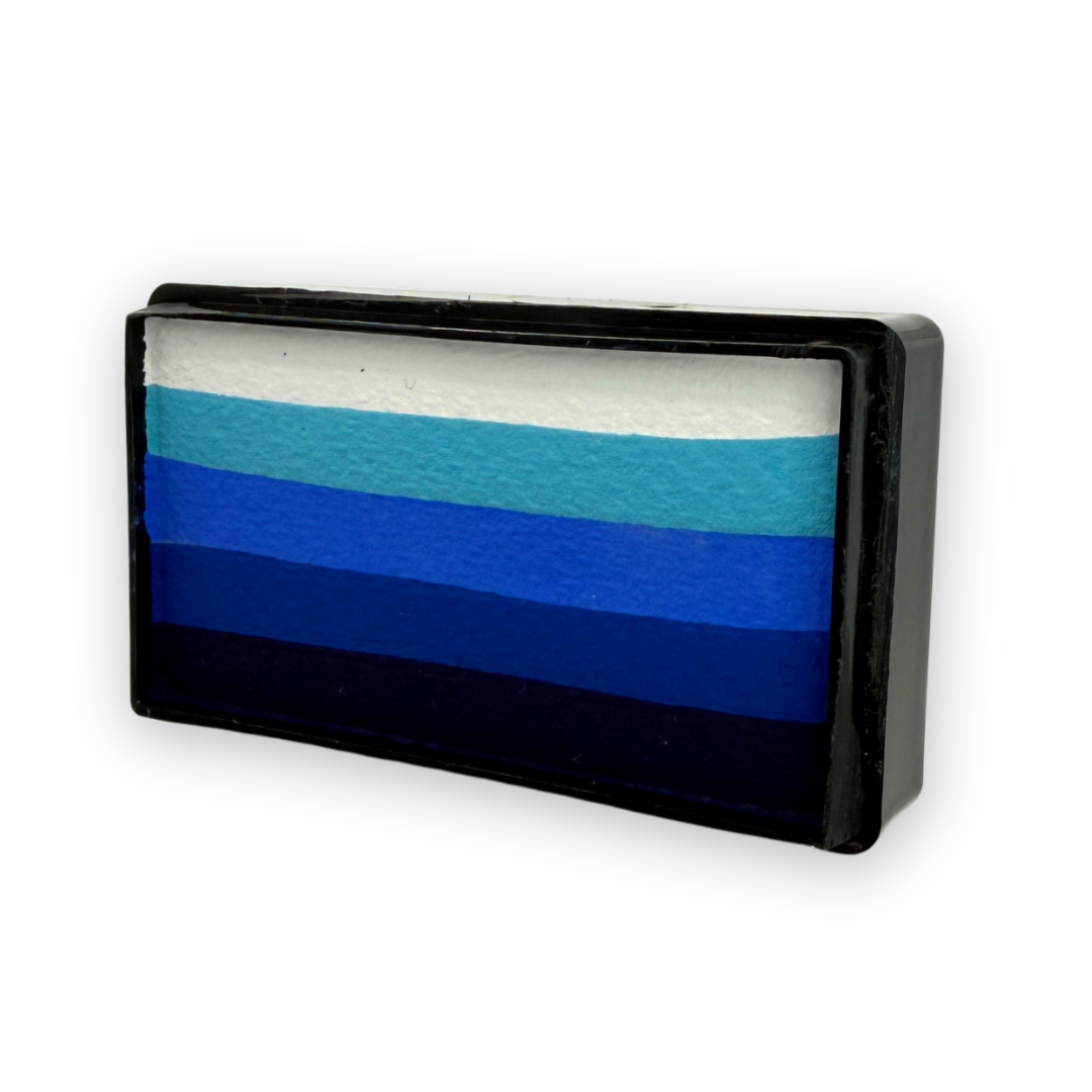 Angled view of the Out of the Blue Arty Cake 28g showing five layered shades from white to deep navy in a rectangular one-stroke face paint cake designed for smooth blue gradient face painting.