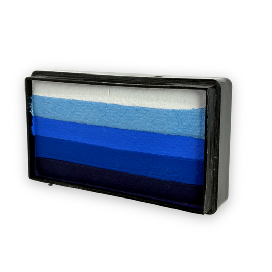 Angled view of the Out of the Blue Arty Cake 28g showing five layered shades from white to deep navy in a rectangular one-stroke face paint cake designed for smooth blue gradient face painting.