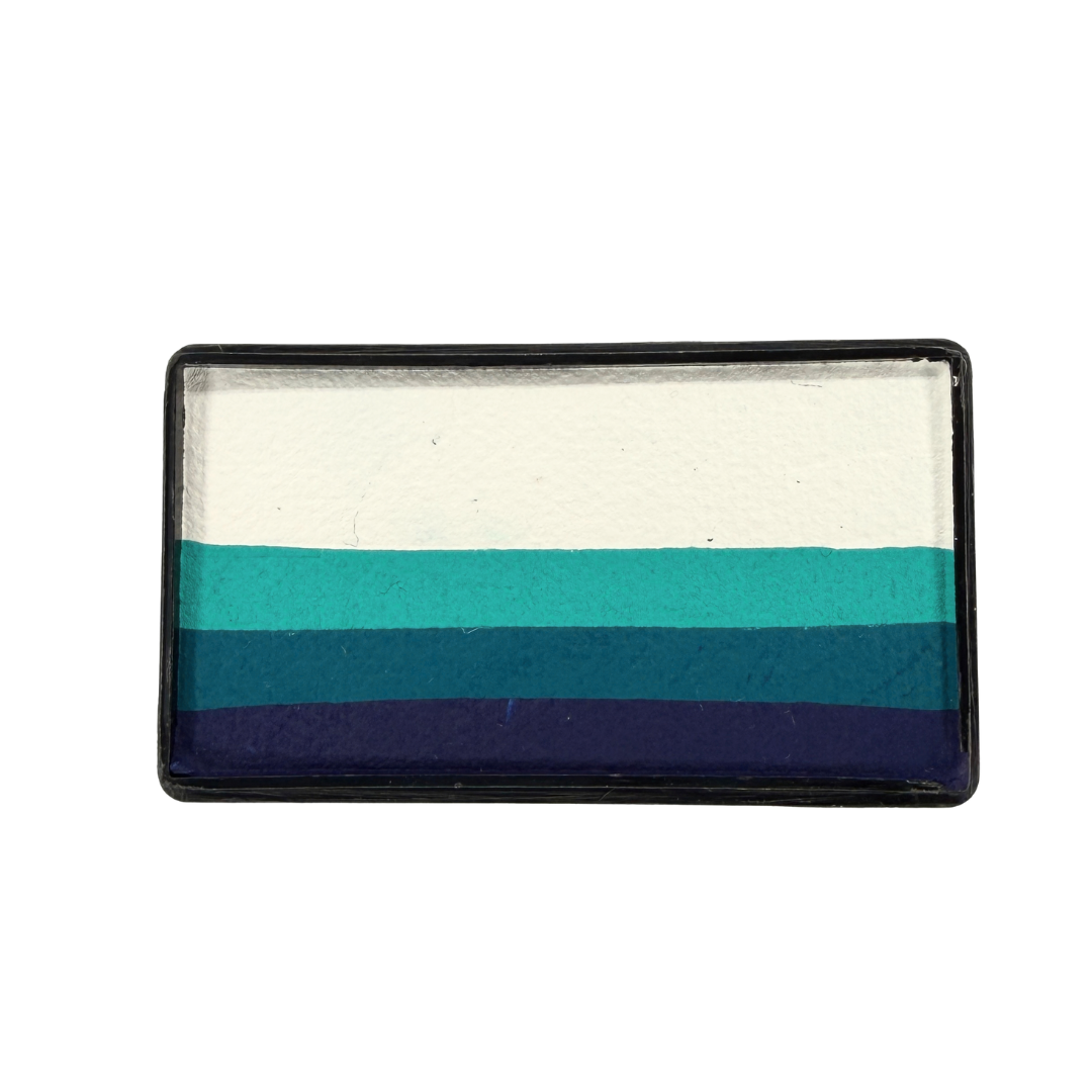 Blue Bonnet Arty Cake 28g limited edition one-stroke face paint featuring white, aqua, deep teal, and navy blue layers, designed with Paty De Leon.