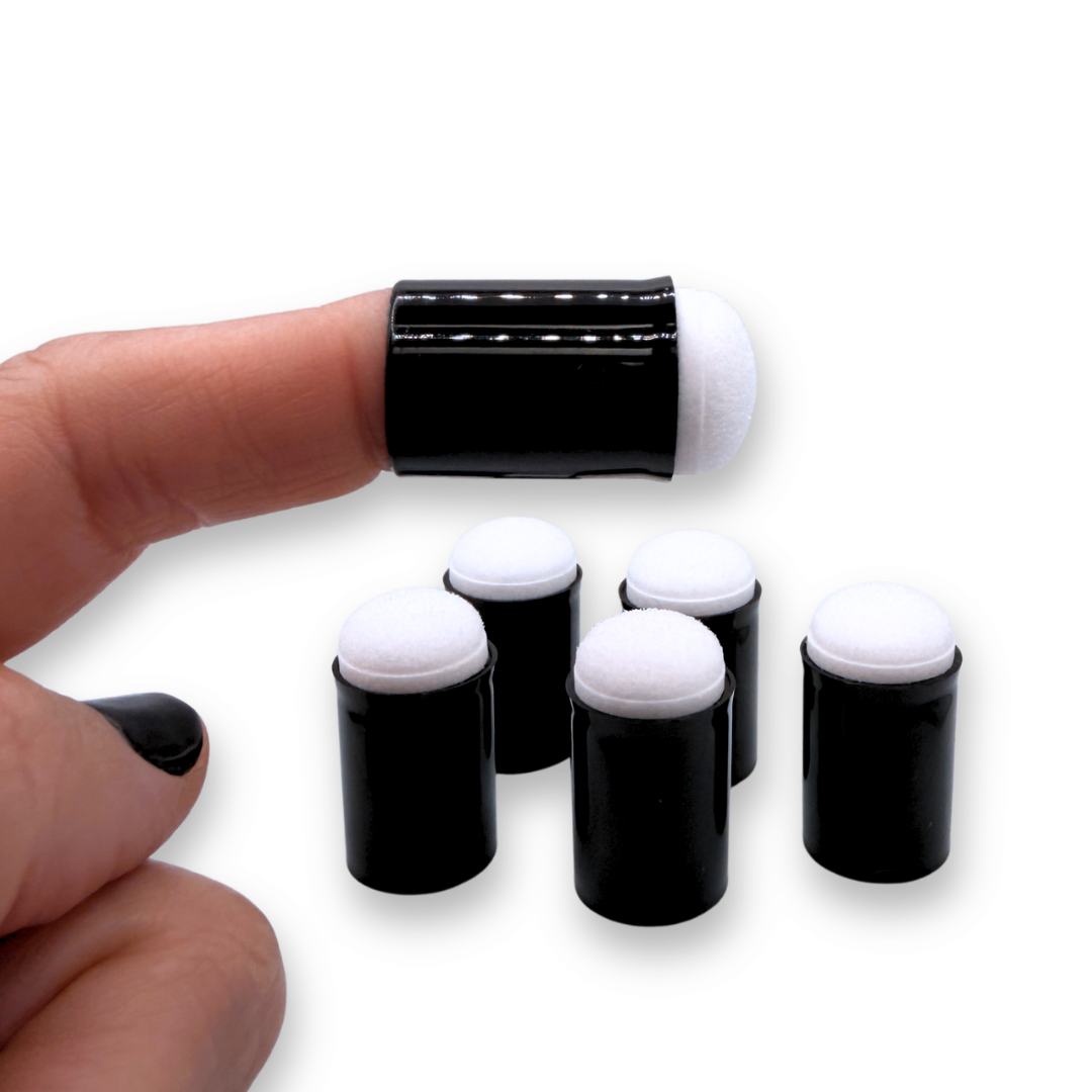 A close-up of a hand wearing a black finger dauber with a white foam tip, with four more of the same arranged below on a plain white background.
