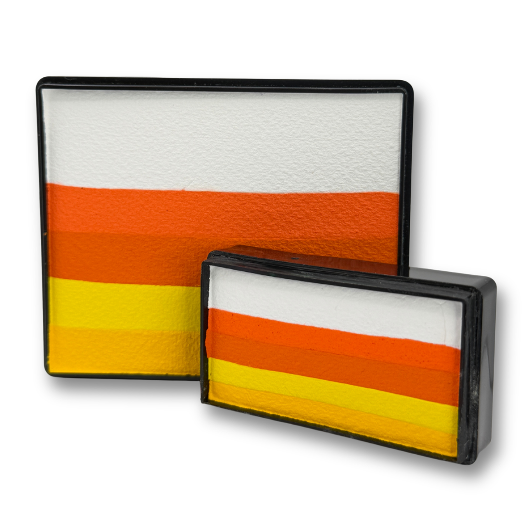 Candy Corn Face Paint Bundle featuring the limited-edition Candy Corn Rainbow Cake 50g and Candy Corn Arty Cake 28g with layered white, orange, yellow, and golden yellow face paint for Halloween and fall one-stroke designs.