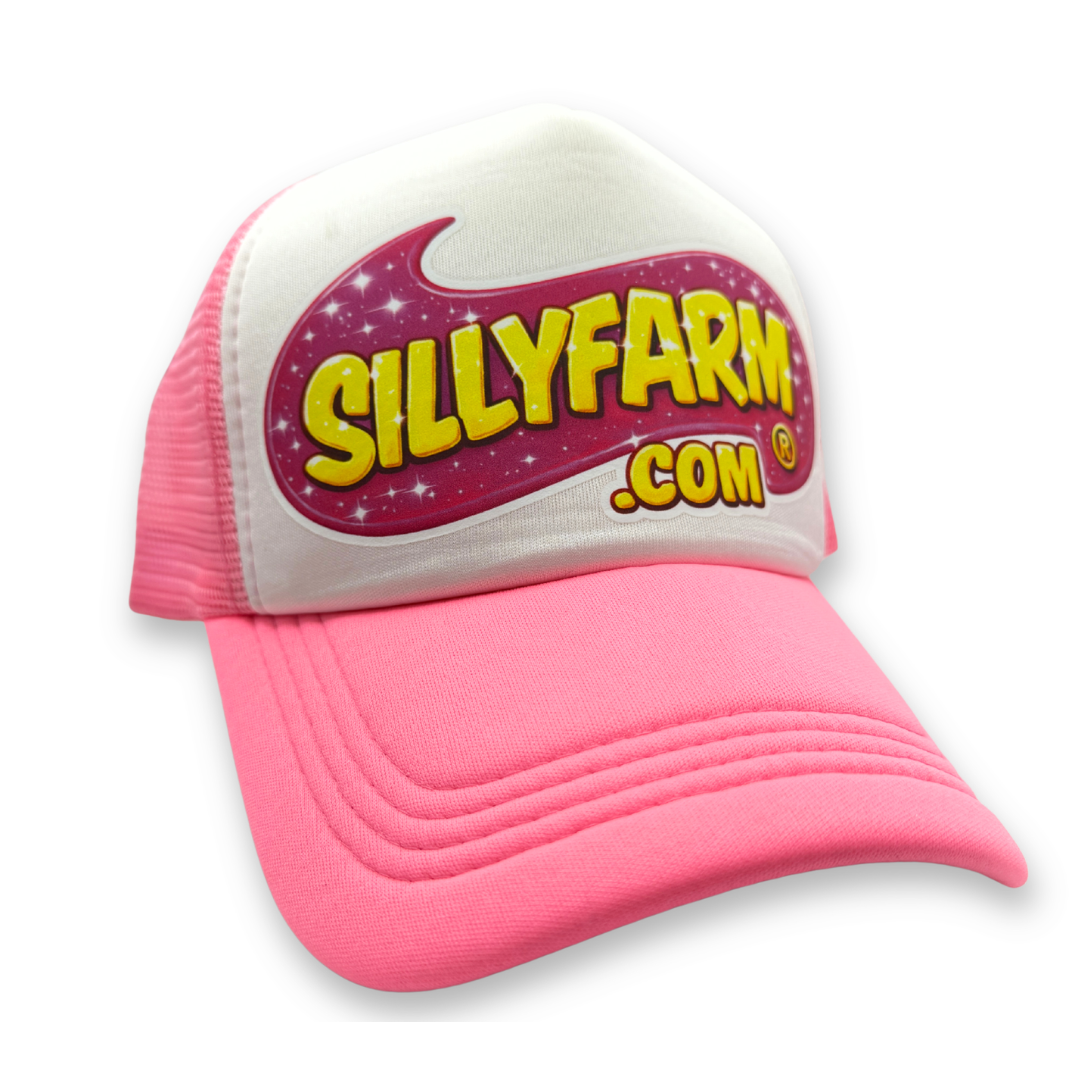 Angled front view of the SillyFarm Pink Trucker Snapback Hat with a white foam front, bright pink curved bill, breathable pink mesh sides, and the iconic SillyFarm logo.