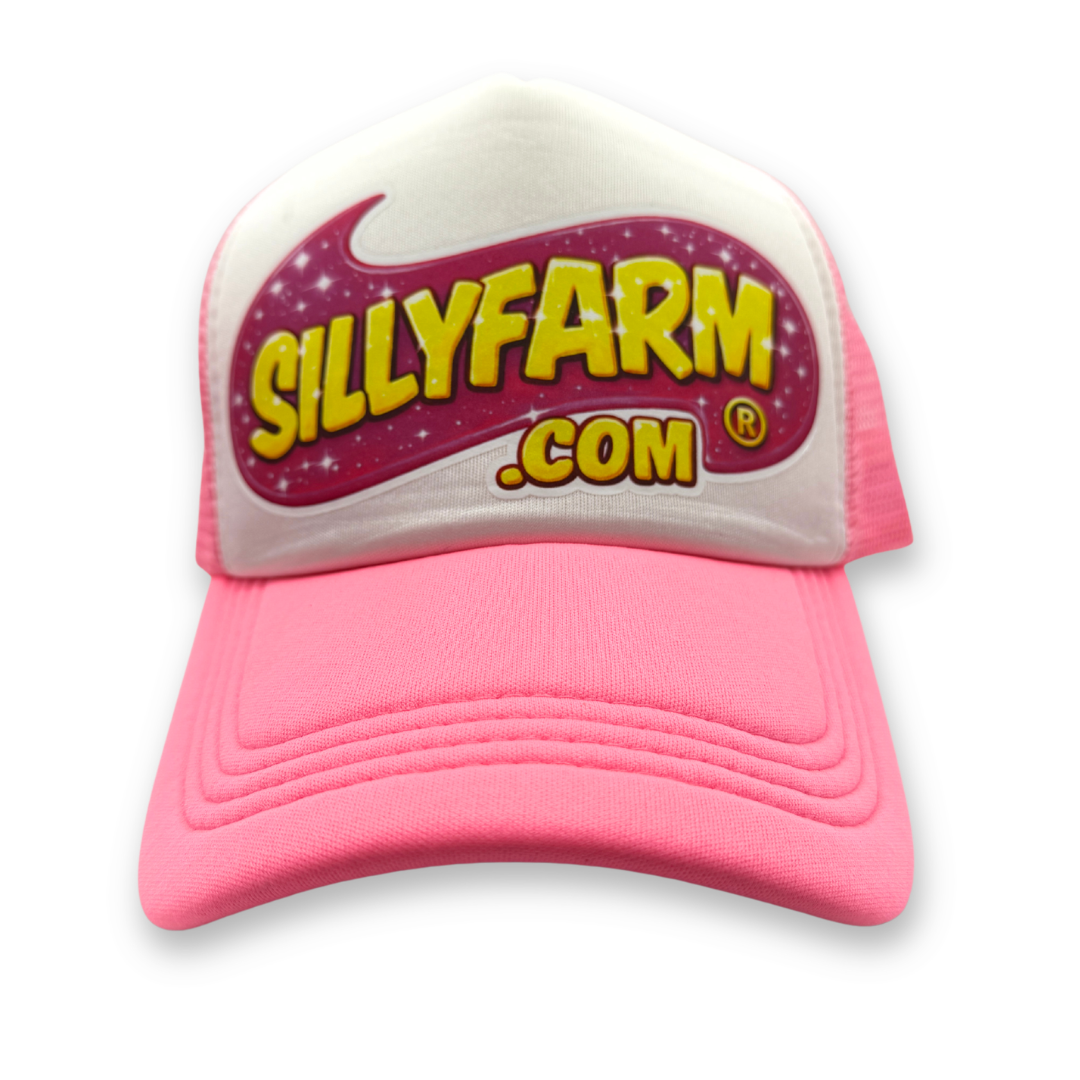 SillyFarm Pink Trucker Snapback Hat featuring a white foam front, bright pink curved bill, pink mesh back, and the classic SillyFarm logo on the front panel.