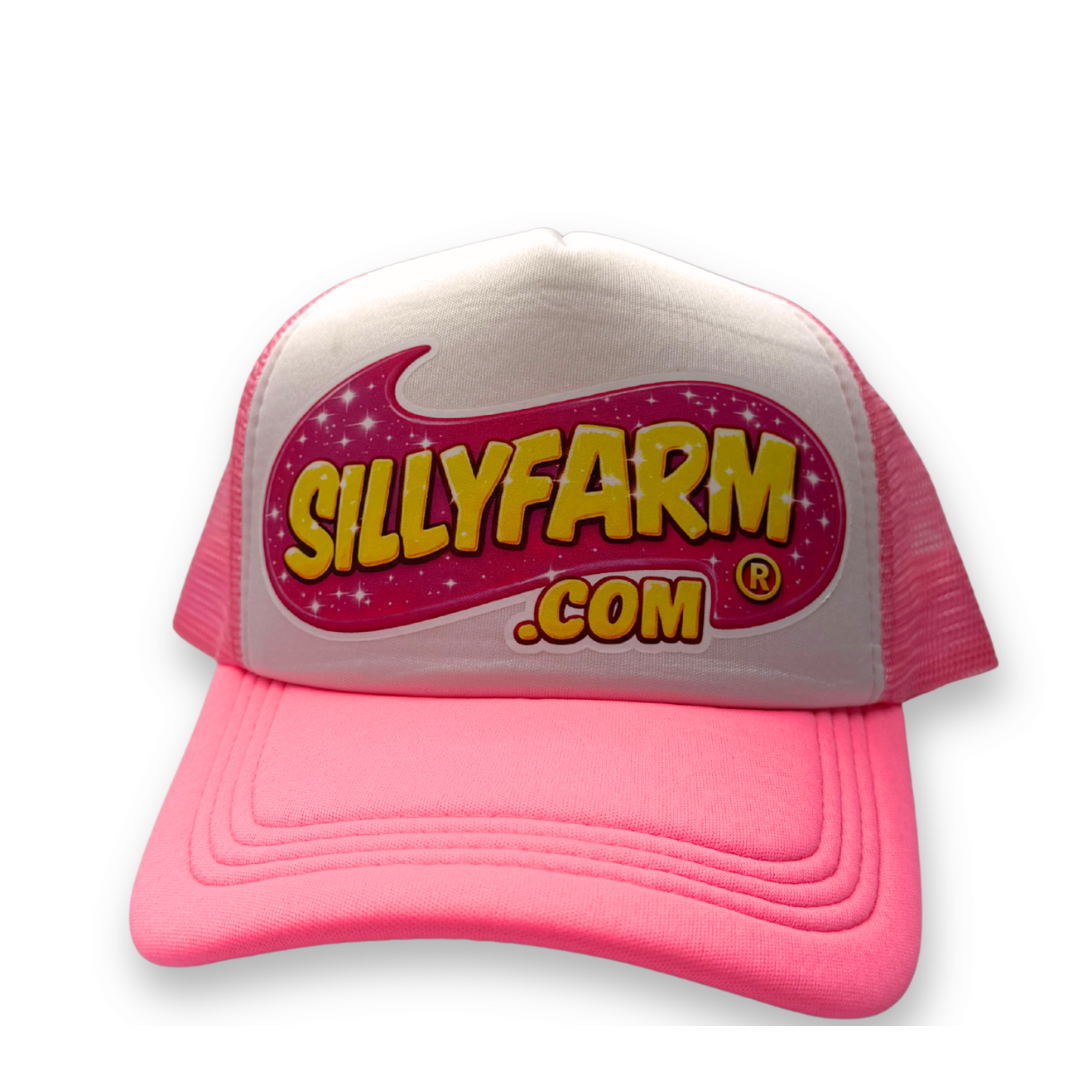 SillyFarm Pink Trucker Snapback Hat featuring a white foam front, bright pink curved bill, pink mesh back, and the classic SillyFarm logo on the front panel.
