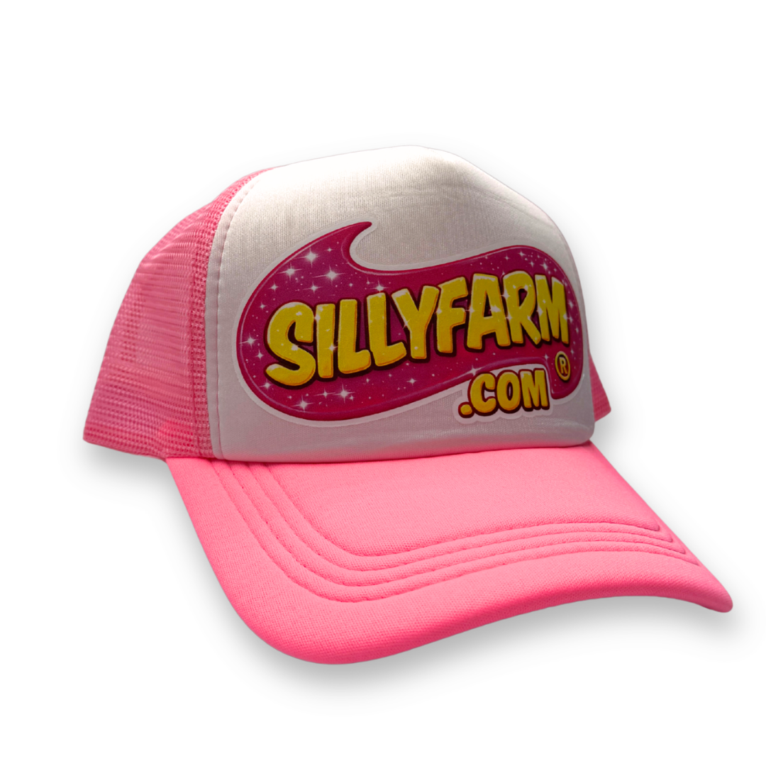 Angled front view of the SillyFarm Pink Trucker Snapback Hat with a white foam front, bright pink curved bill, breathable pink mesh sides, and the iconic SillyFarm logo.