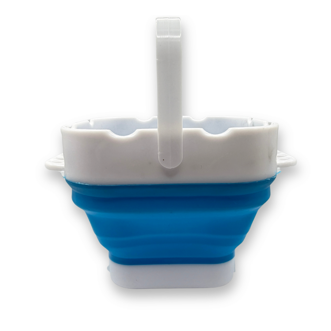 Blue SillyFarm Pop n Go Collapsible Water Cup expanded with folding carry handle upright, featuring multiple brush rests and a 16 oz capacity for rinsing face painting brushes.