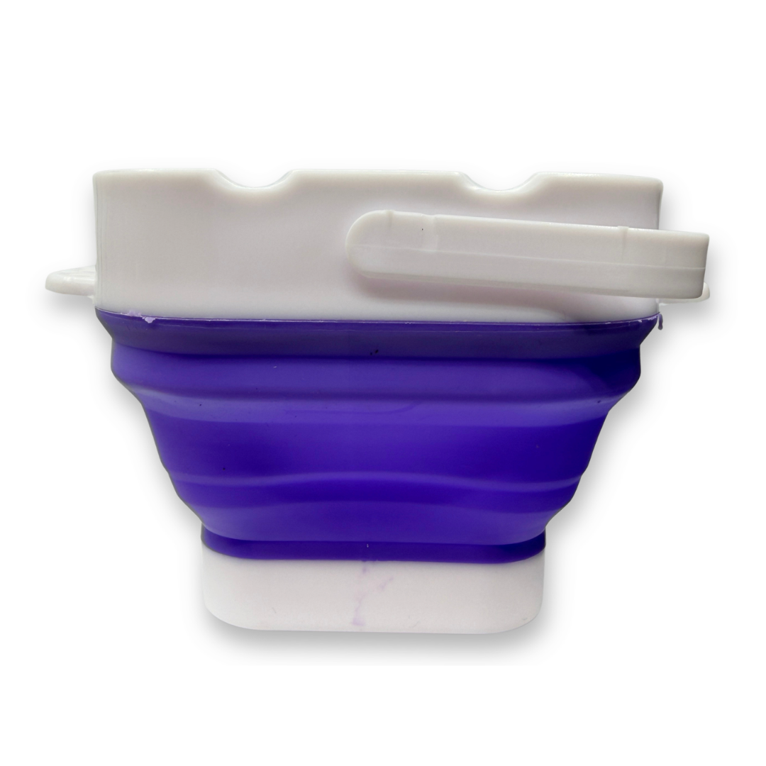 Purple SillyFarm Pop n Go Collapsible Water Cup with flexible silicone body, folding carry handle, and built-in brush rests. Holds up to 16 oz and folds flat for storage.