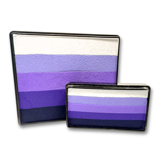 Grape Escape Rainbow Cake and matching Arty Cake featuring coordinated shades of white, lavender, violet, purple, and deep plum face paint displayed together as a one-stroke face paint bundle.