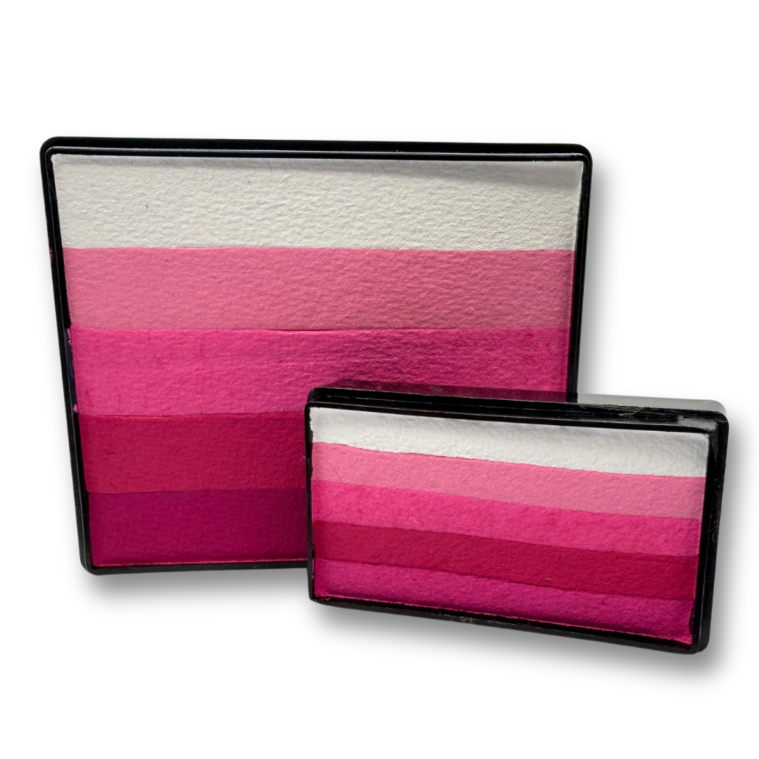 Pinky Winky Rainbow Cake and matching Arty Cake featuring five coordinated shades of white, light pink, hot pink, magenta, and berry face paint displayed together as a one-stroke face paint bundle.
