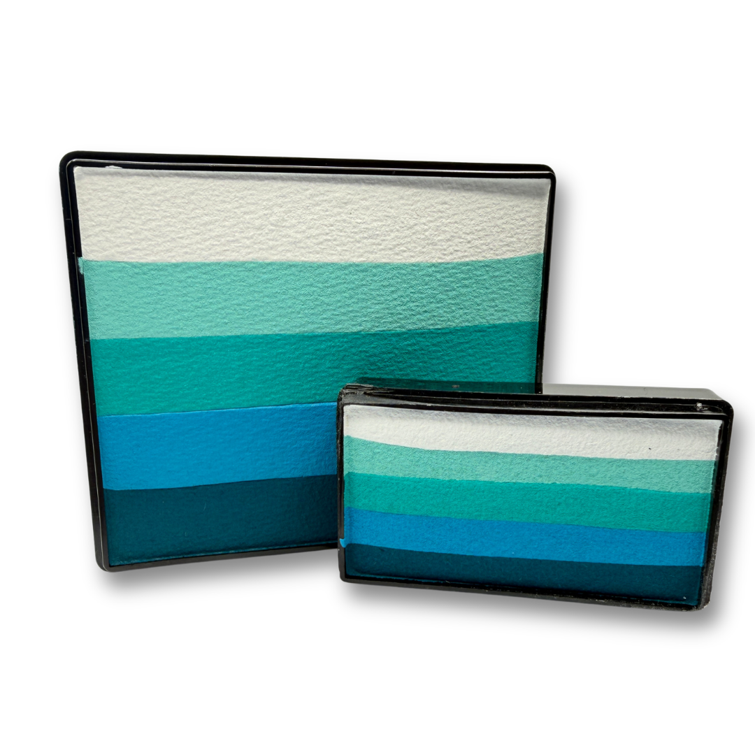 Sea Glass Rainbow Cake and matching Arty Cake featuring coordinated shades of white, mint, teal, turquoise, blue, and deep teal face paint displayed together as a one-stroke face paint bundle.