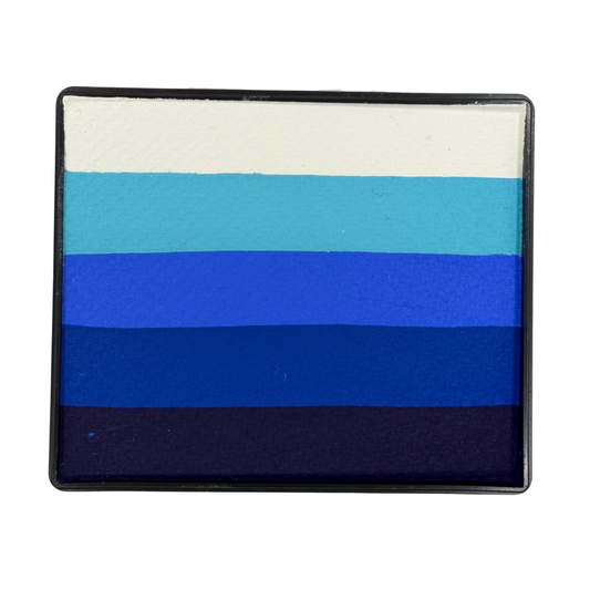 Blue gradient Rainbow Cake face paint with layered stripes of white, light blue, bright blue, royal blue, and deep navy in a rectangular container.