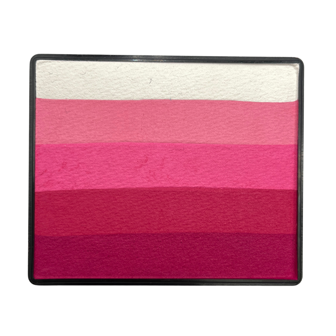 Pink gradient Rainbow Cake face paint with layered stripes of white, light pink, bright pink, deep pink, and berry tones in a rectangular container on a white background