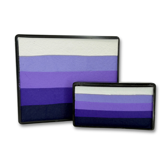 Grape Escape Rainbow Cake and matching Arty Cake featuring coordinated shades of white, lavender, violet, purple, and deep plum face paint displayed together as a one-stroke face paint bundle.