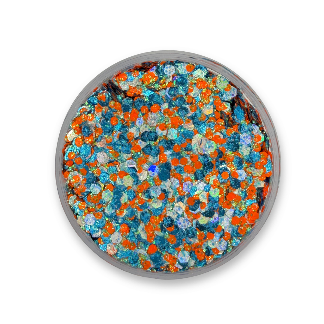 Open jar of Amplified Studio Sparkle Glitter Cream showing turquoise blue, iridescent silver, and bright orange chunky cosmetic glitter mix.