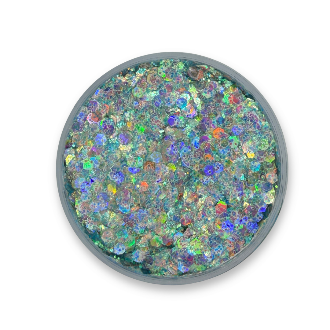 Open jar of Blue Eyed Boy Studio Sparkle Glitter Cream showing chunky iridescent cosmetic glitter with blue, aqua, silver, and rainbow reflections.