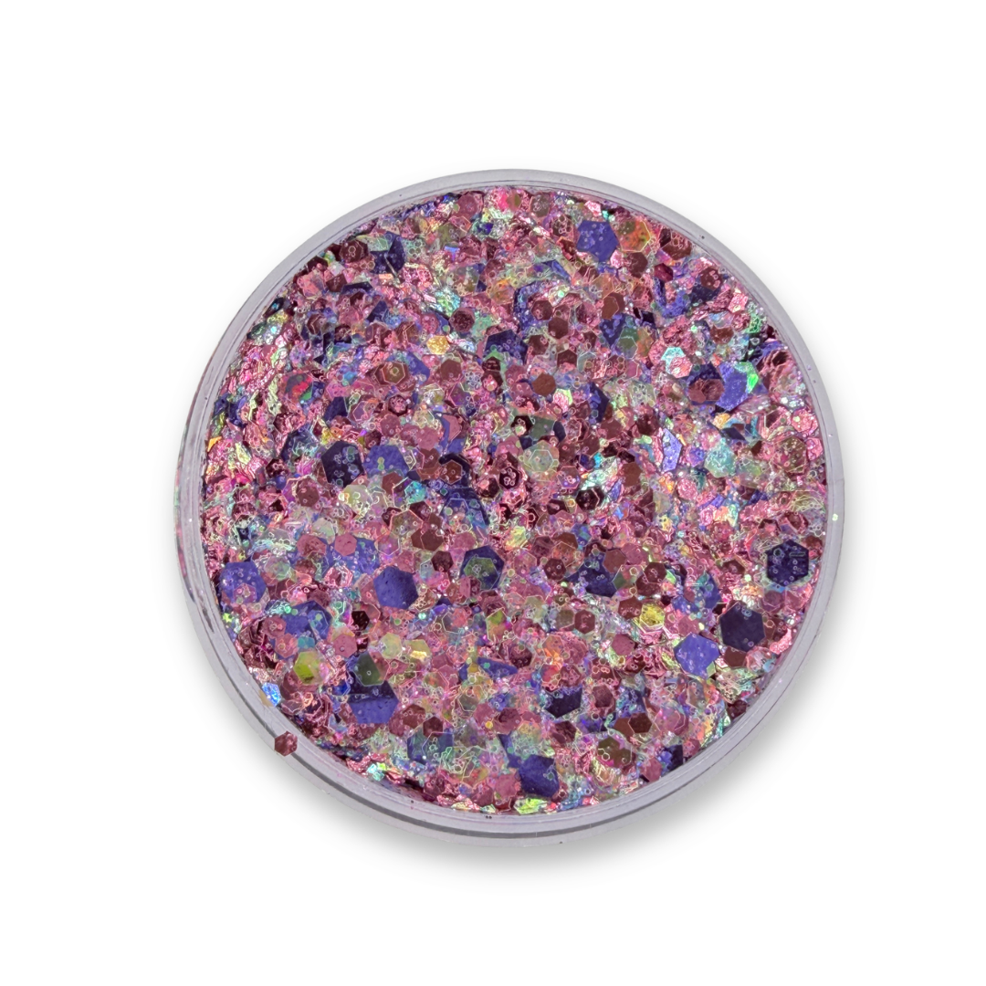 Open jar of Fairy-In-Training Studio Sparkle Glitter Cream showing chunky pink, purple, and iridescent cosmetic glitter mix with rainbow reflections.