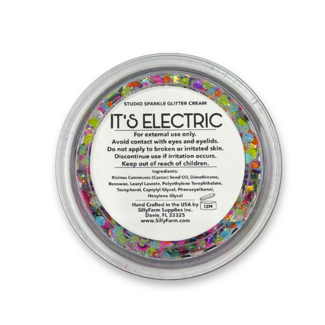 Back view of It's Electric Studio Sparkle Glitter Cream container showing the product label, ingredients, safety information, and usage details. ✨
