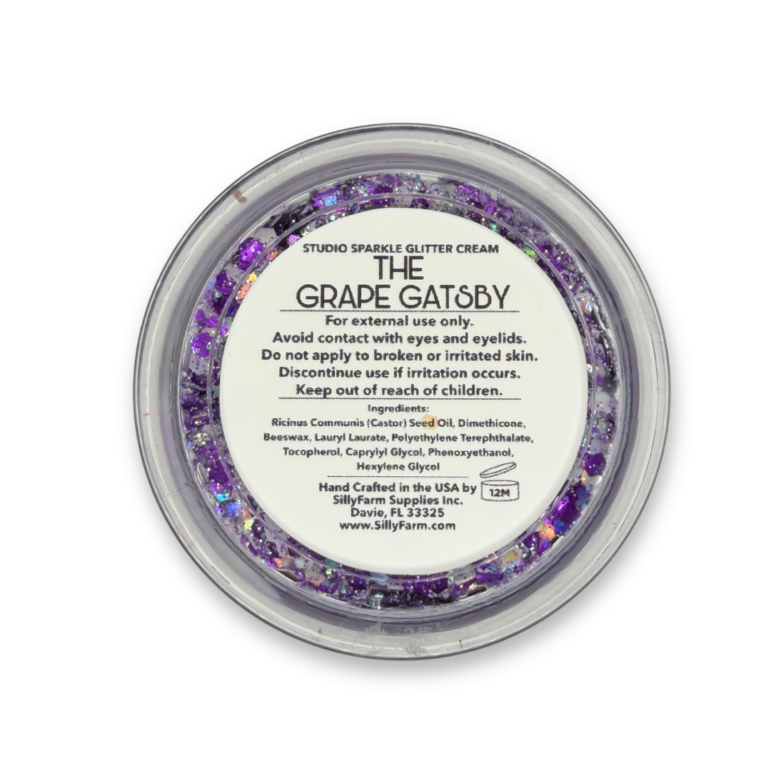Back view of The Grape Gatsby Studio Sparkle Glitter Cream container showing the product label, ingredients, safety information, and usage details.