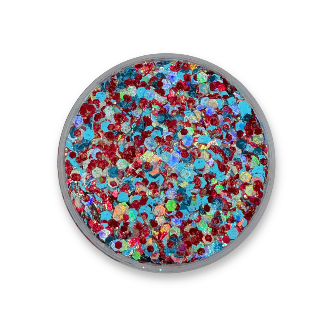 Open jar of The Washingtons Studio Sparkle Glitter Cream showing chunky red, aqua blue, iridescent silver, and holographic cosmetic glitter mix.
