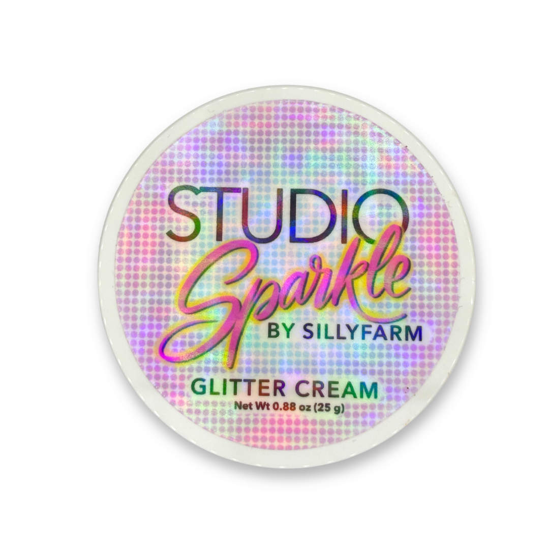 Top view of Amplified Studio Sparkle Glitter Cream container showing the holographic Studio Sparkle by SillyFarm product label.