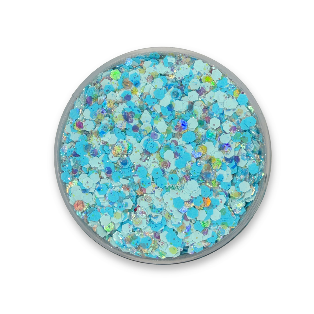Open jar of Campeones Studio Sparkle Glitter Cream featuring sky blue, icy white, and iridescent cosmetic glitter inspired by Argentina soccer fan colors.