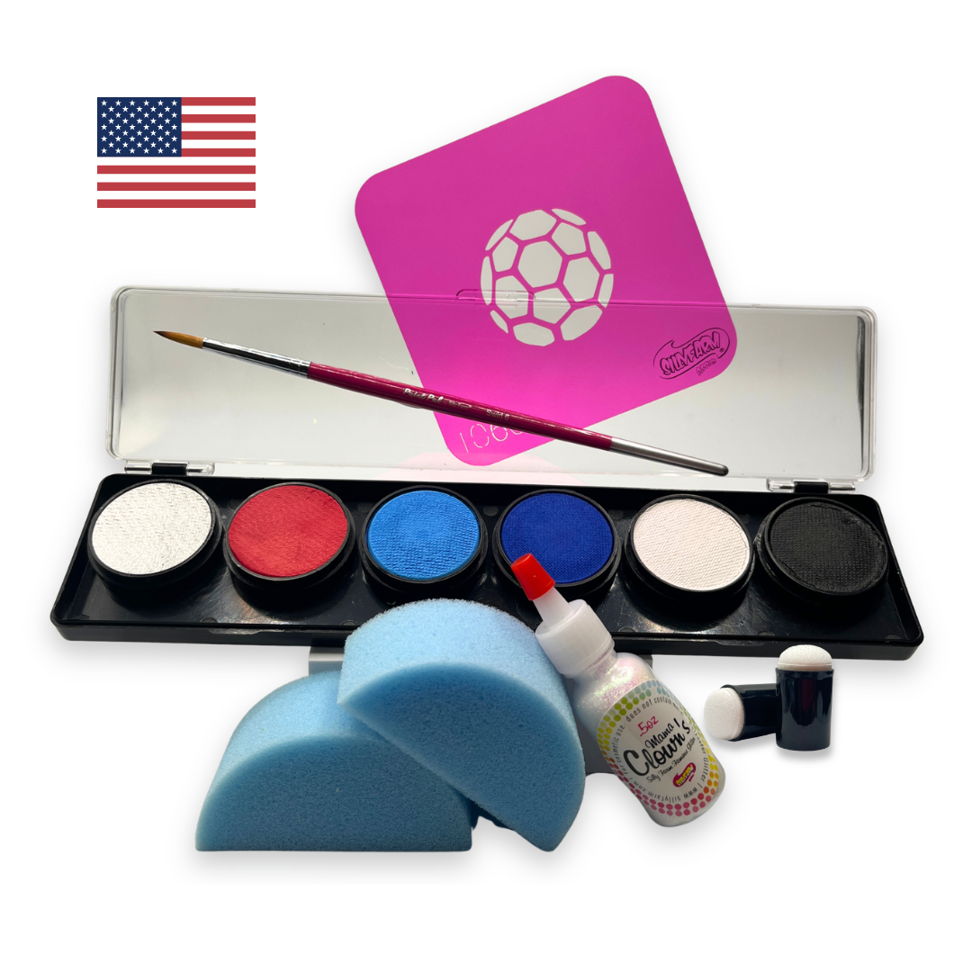 USA-themed soccer fan face paint kit featuring a 6-color water activated palette with red, white, blue, black, and light blue paints, a pink soccer stencil, professional round brush, two blue face painting sponges, a bottle of Mama Clown glitter, and foam daubers displayed on a white background.