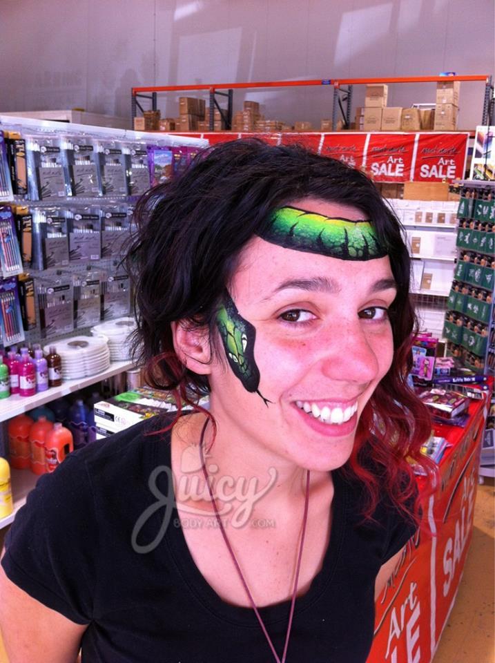 Face paint design using Arty Cakes, showing bold, multi-color effects in one stroke for dynamic face and body art.
